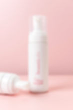Product image of self tanner on a pink backdrop 
