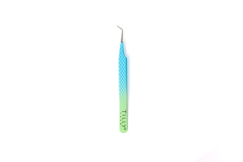 Eyelash tool in a blue and green colour sitting on a white background. 
