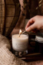 Lifestyle image of a candle being lit with a match 