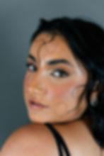 Model shot from a beauty campaign shot on a grey backdrop 